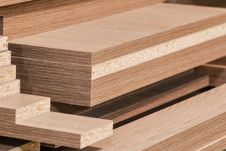 Multiple stacks of cut medium-density fiberboard (MDF) panels in different sizes, with finished and unfinished edges.