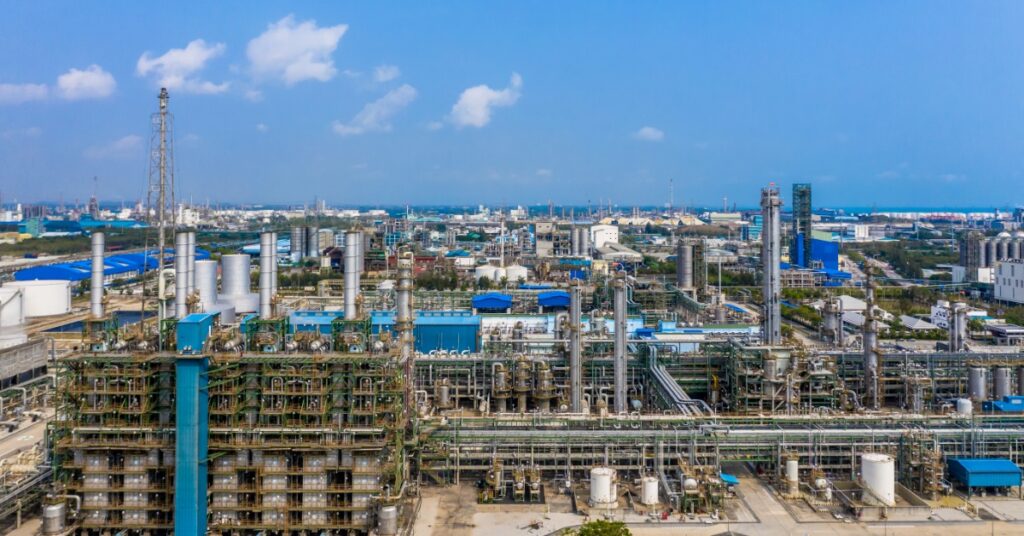 An industrial facility during the day. The sky is blue with minimal cloud coverage over the area.